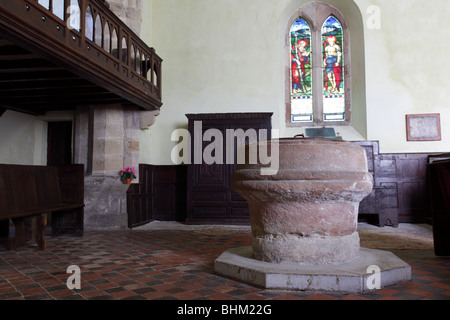 The stone Font inside the village church of St Andrew`s in Wroxeter,Shropshire,UK. Stock Photo